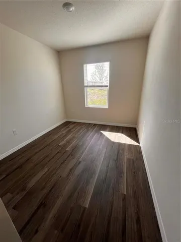 a view of an empty room and wooden floor