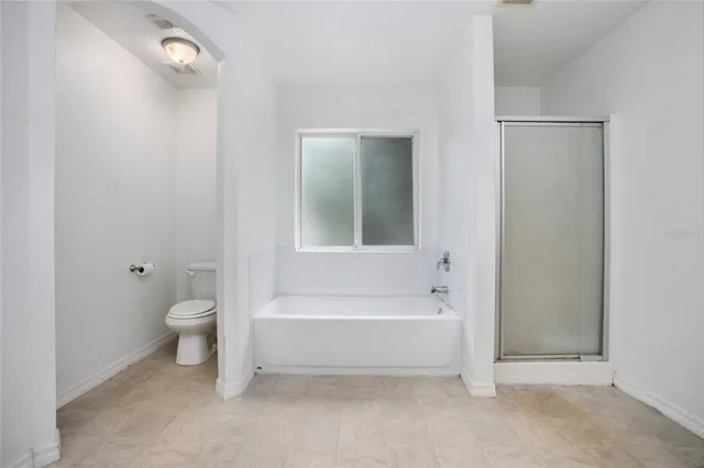 a bathroom with a bathtub and a toilet