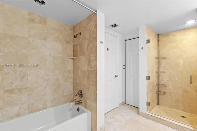 a bathroom with a bathtub shower and a sink