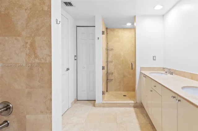 a bathroom with a granite countertop sink a shower and a mirror