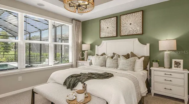 a bedroom with a bed and a painting on the wall