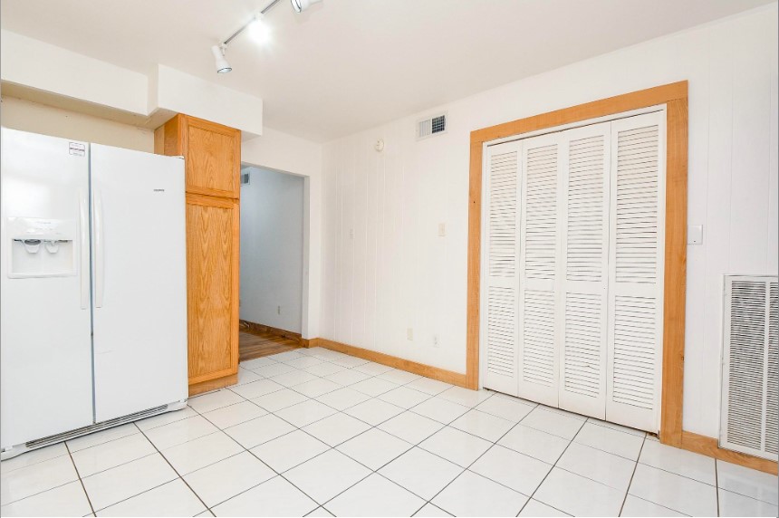 7233 Beechnut Street, Unit A Houston, TX 77074 - Photo 14 of 40 a view of an empty room with wooden floor and a cabinet