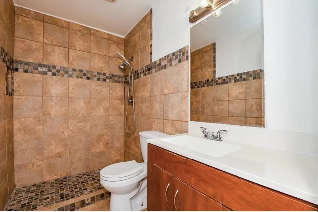 a bathroom with a sink toilet and shower