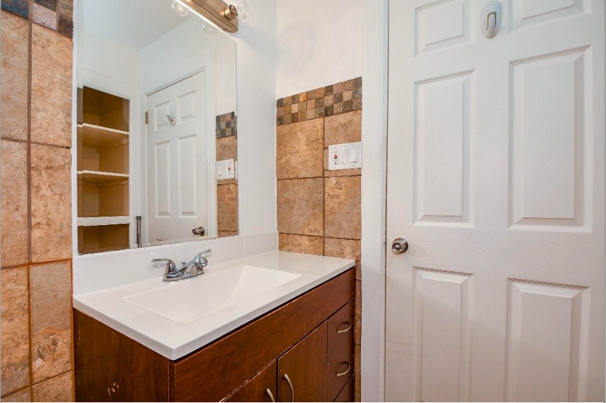 7233 Beechnut Street, Unit A Houston, TX 77074 - Photo 26 of 40 a bathroom with a sink vanity and a mirror