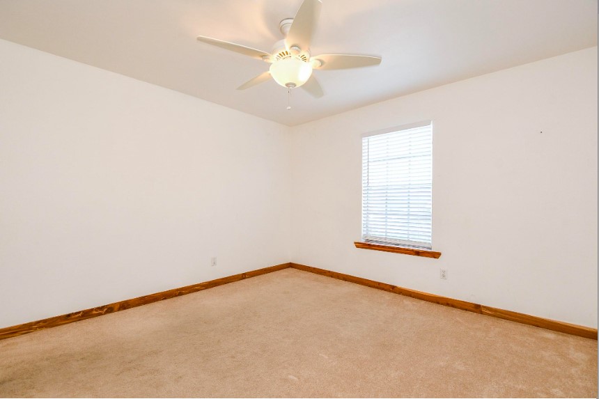 7233 Beechnut Street, Unit A Houston, TX 77074 - Photo 30 of 40 an empty room with a chandelier fan and windows