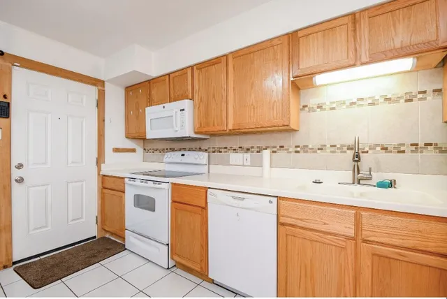 a kitchen with stainless steel appliances granite countertop a sink and cabinets