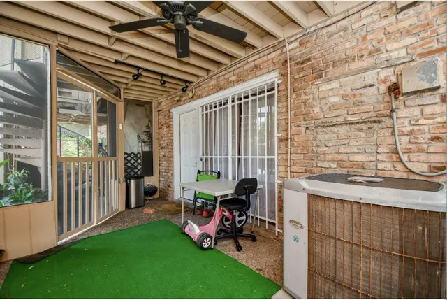 a view of a porch with chairs and backyard