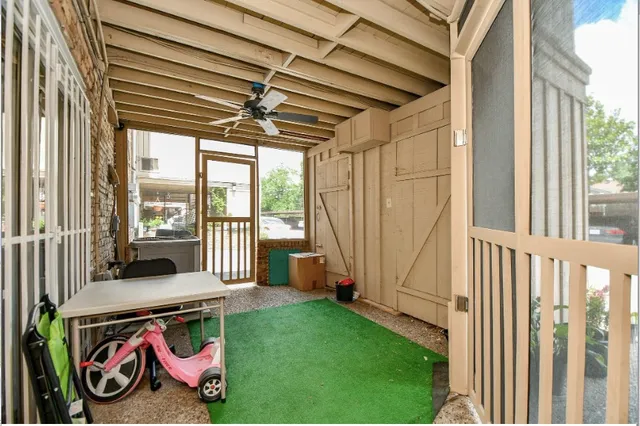 a view of a brick house with large windows