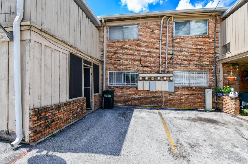 7233 Beechnut Street, Unit A Houston, TX 77074 - Photo 37 of 40 a view of a brick house with large windows