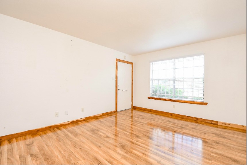 7233 Beechnut Street, Unit A Houston, TX 77074 - Photo 6 of 40 an empty room with wooden floor and windows