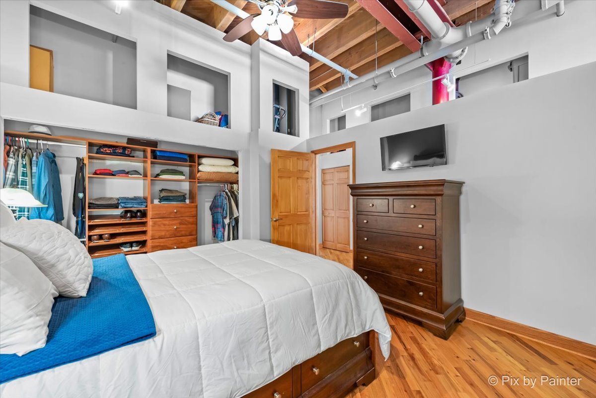 1601 South Indiana Avenue, Unit 306 Chicago, IL 60616 - Photo 15 of 25 a bedroom with a bed and a tv