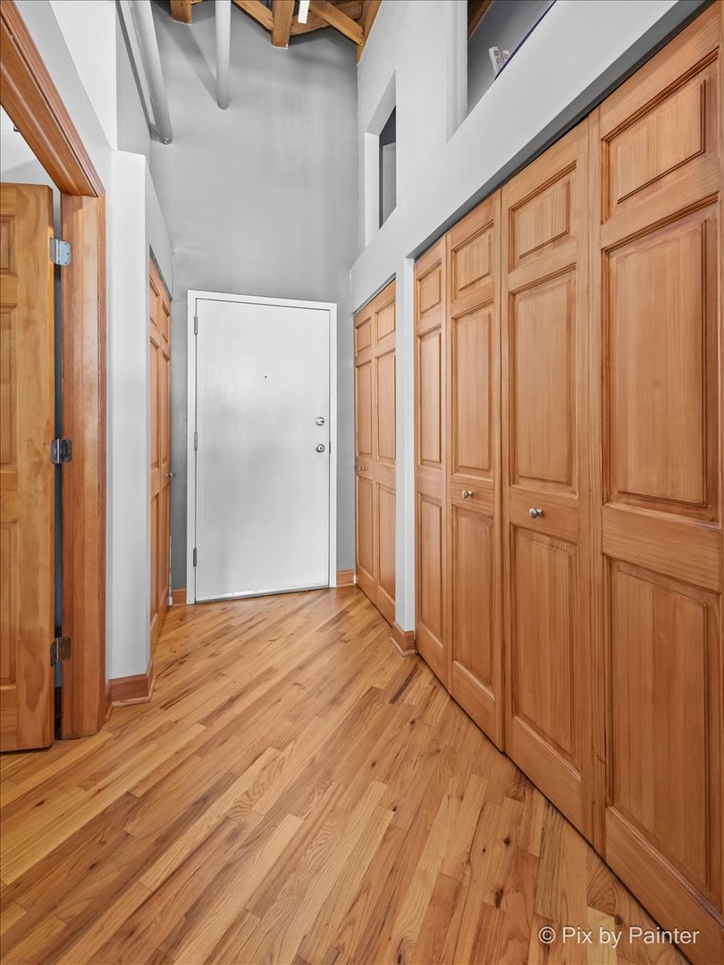 1601 South Indiana Avenue, Unit 306 Chicago, IL 60616 - Photo 3 of 25 a view of a closet with wooden floor