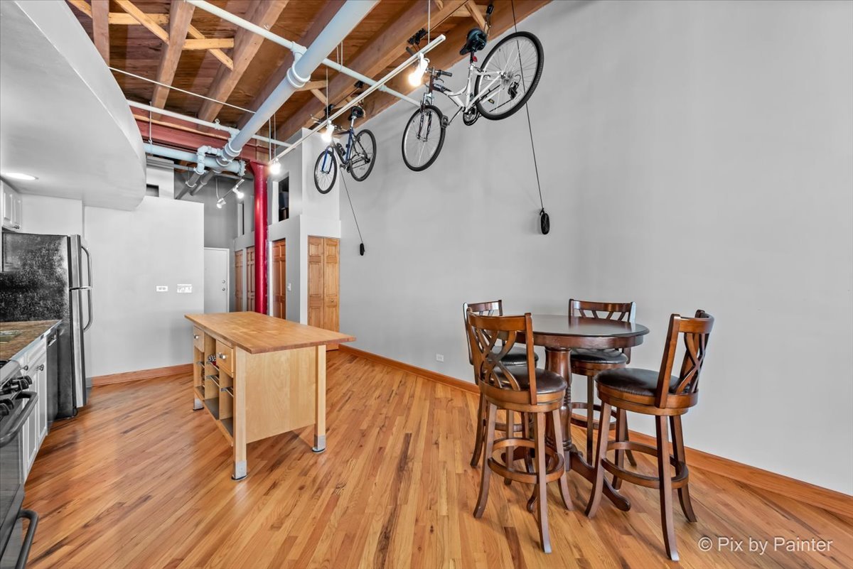 1601 South Indiana Avenue, Unit 306 Chicago, IL 60616 - Photo 7 of 25 a view of a dining room with furniture and wooden floor