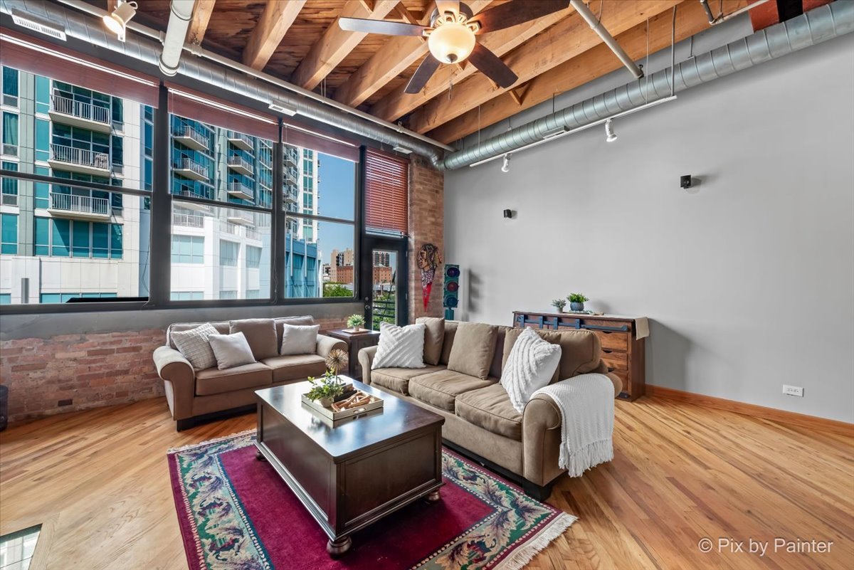 1601 South Indiana Avenue, Unit 306 Chicago, IL 60616 - Photo 8 of 25 a living room with furniture and a large window