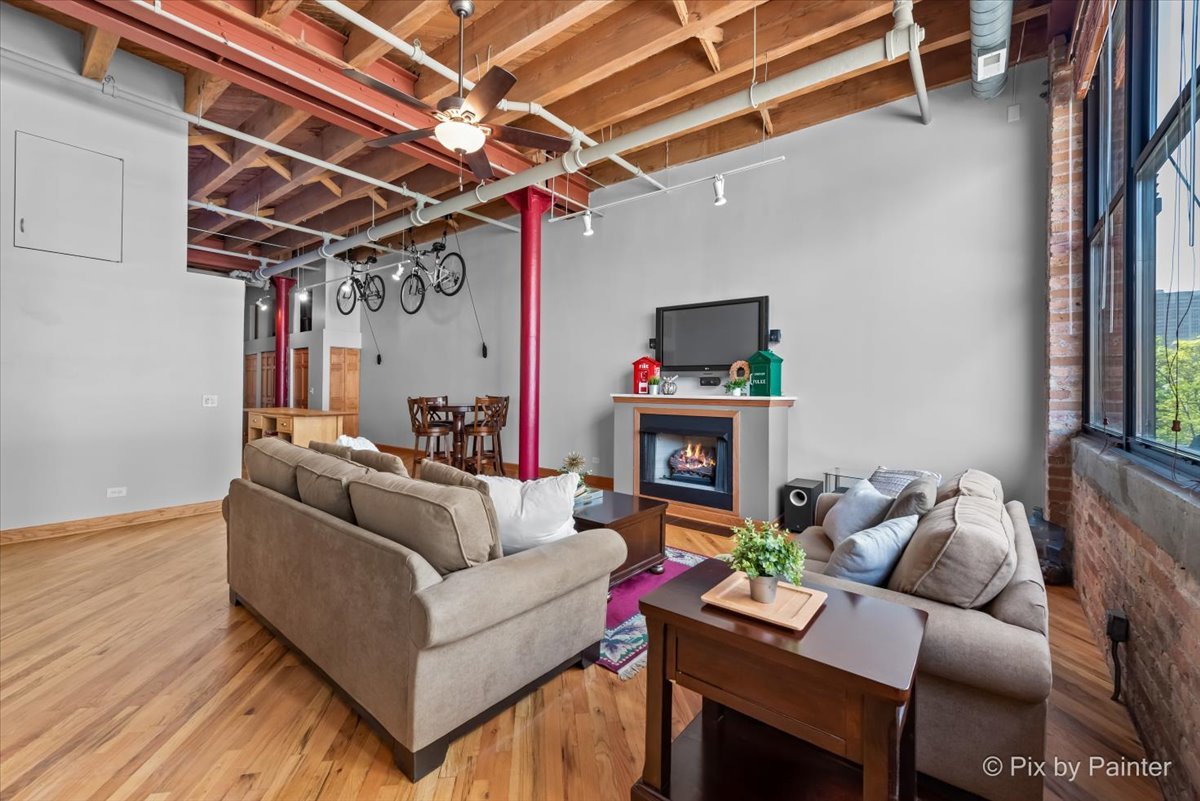 1601 South Indiana Avenue, Unit 306 Chicago, IL 60616 - Photo 10 of 25 a living room with furniture and a fireplace