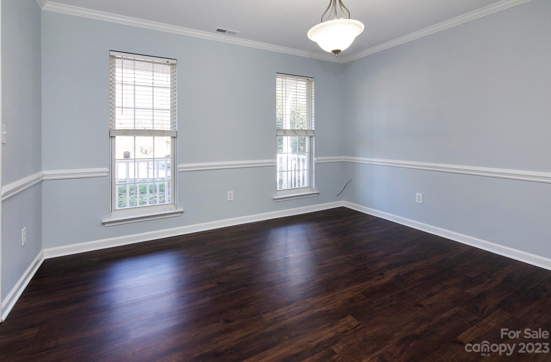 6112 Nevin Road Charlotte, NC 28262 - Photo 12 of 23 an empty room with wooden floor and windows