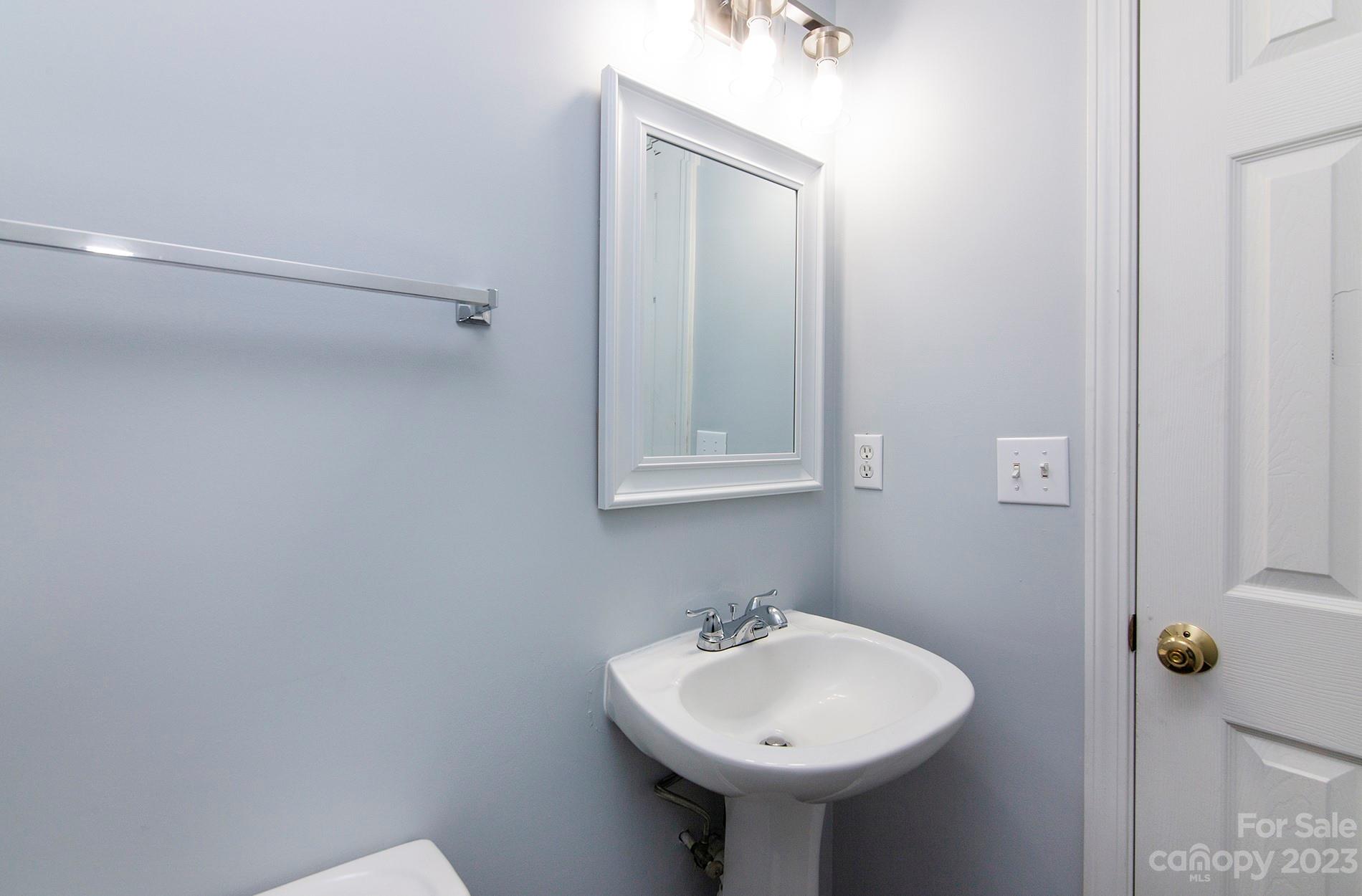 6112 Nevin Road Charlotte, NC 28262 - Photo 13 of 23 a bathroom with a sink and mirror