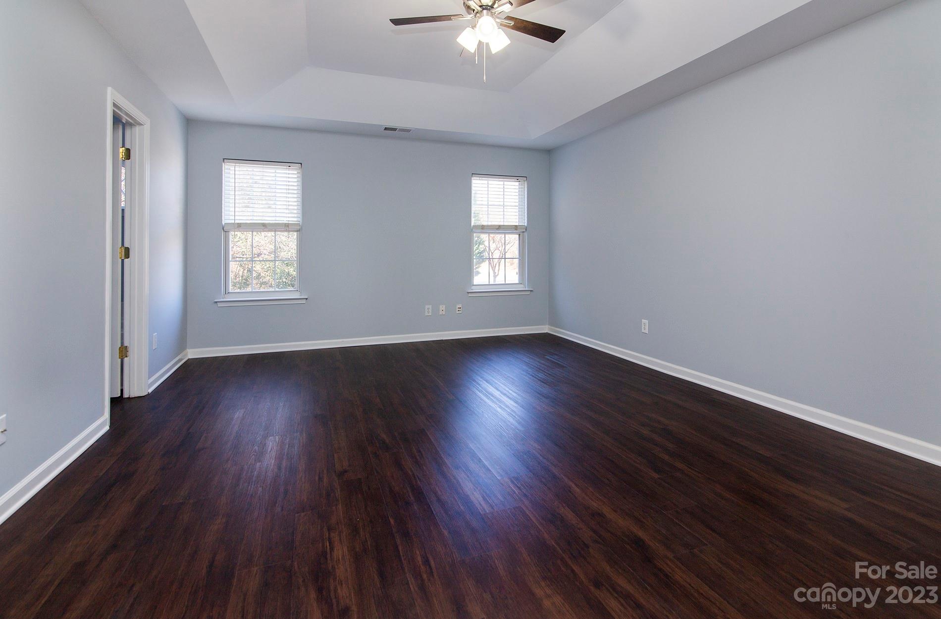 6112 Nevin Road Charlotte, NC 28262 - Photo 14 of 23 an empty room with wooden floor and windows