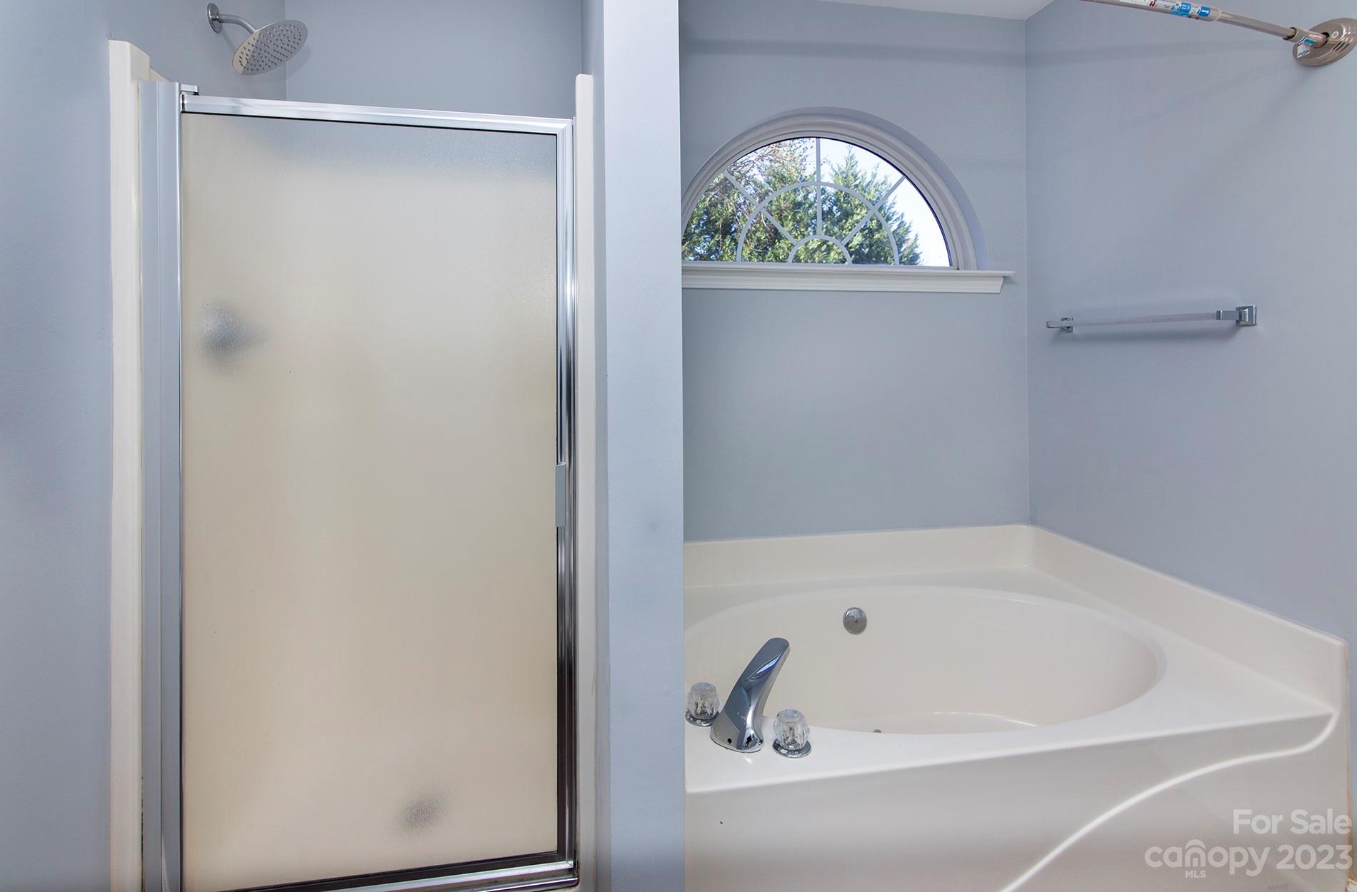 6112 Nevin Road Charlotte, NC 28262 - Photo 16 of 23 a white bath tub with a window