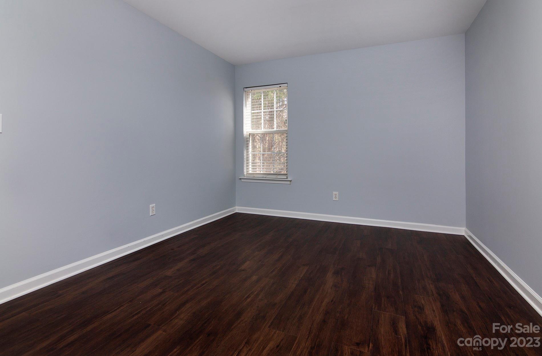 6112 Nevin Road Charlotte, NC 28262 - Photo 19 of 23 a view of an empty room with wooden floor and window