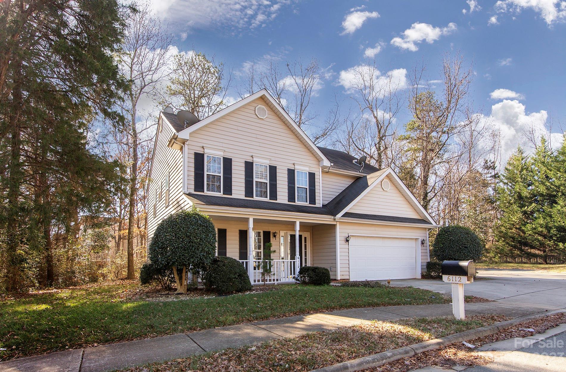 6112 Nevin Road Charlotte, NC 28262 - Photo 2 of 23 a front view of a house with a yard and garage