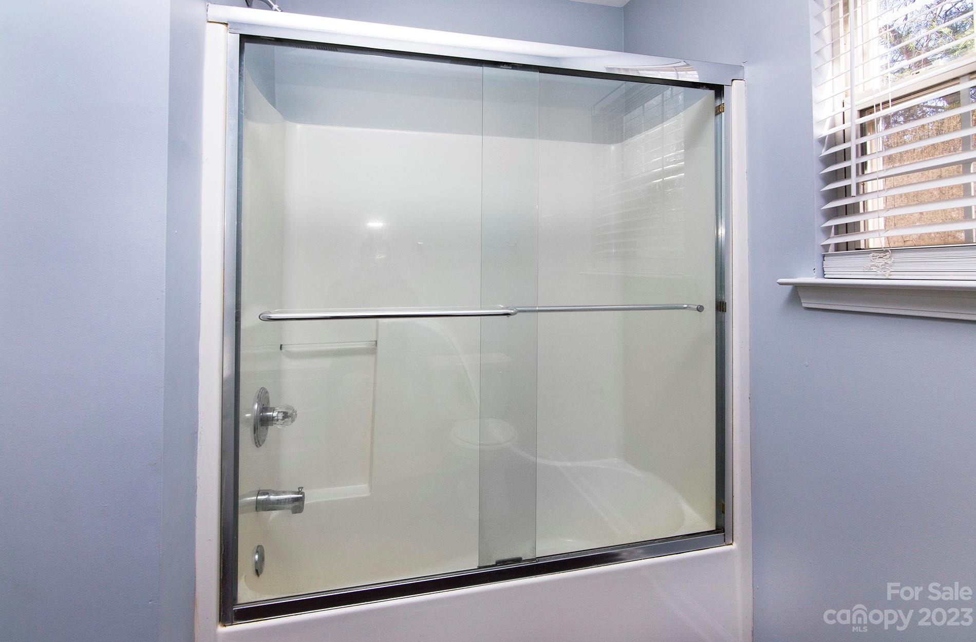 6112 Nevin Road Charlotte, NC 28262 - Photo 22 of 23 a bathroom with a glass shower door