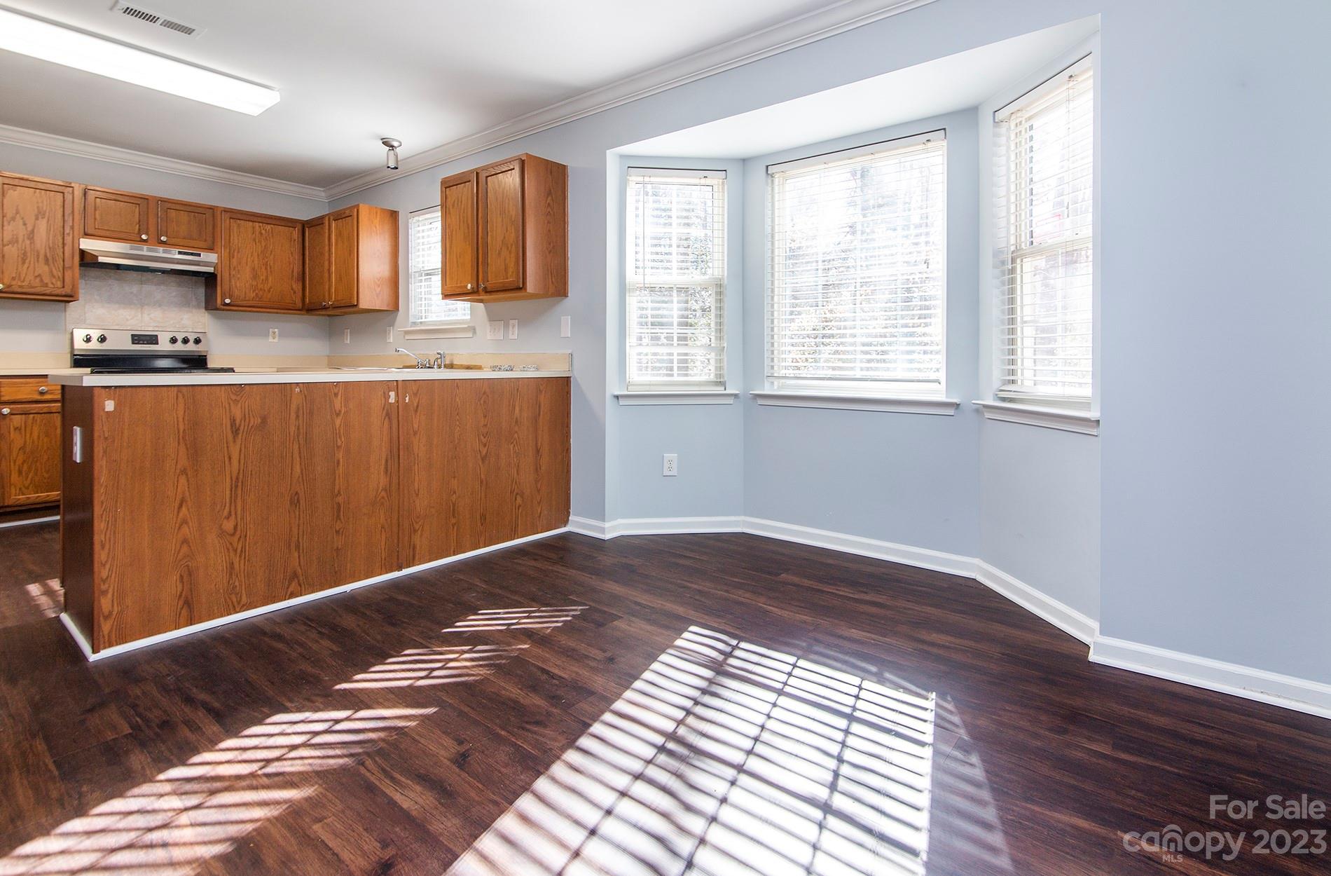6112 Nevin Road Charlotte, NC 28262 - Photo 7 of 23 a view of kitchen with window and wooden floor
