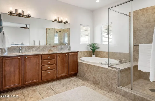 a spacious bathroom with a tub sink and mirror
