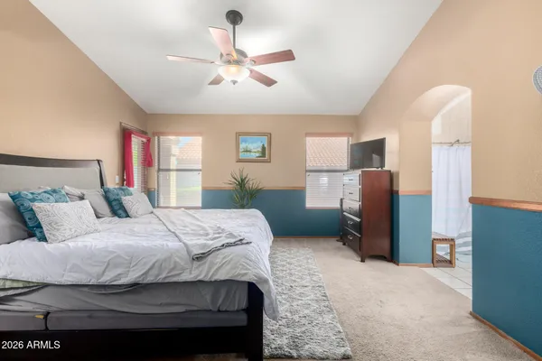 a bedroom with a bed and a chandelier