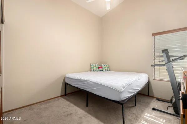a bed sitting in a bedroom next to a window