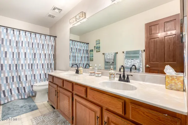 a bathroom with a sink double vanity and a mirror
