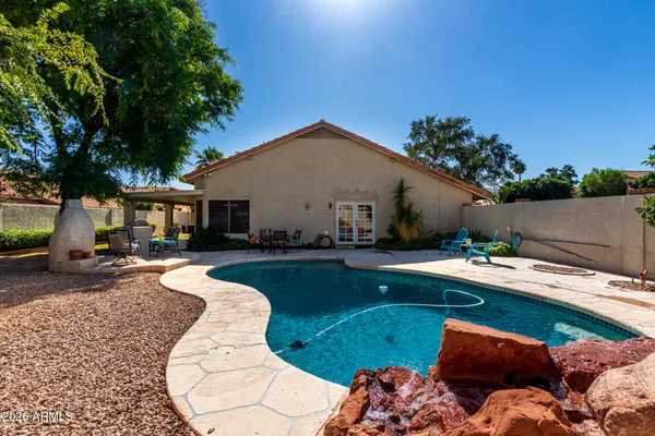 a front view of a house with swimming pool garden and patio