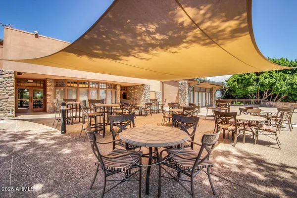 a view of a swimming pool with outdoor seating and a patio