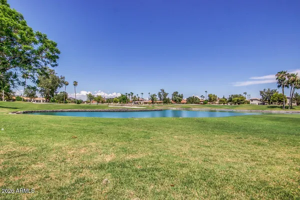 a view of a lake with houses in the background