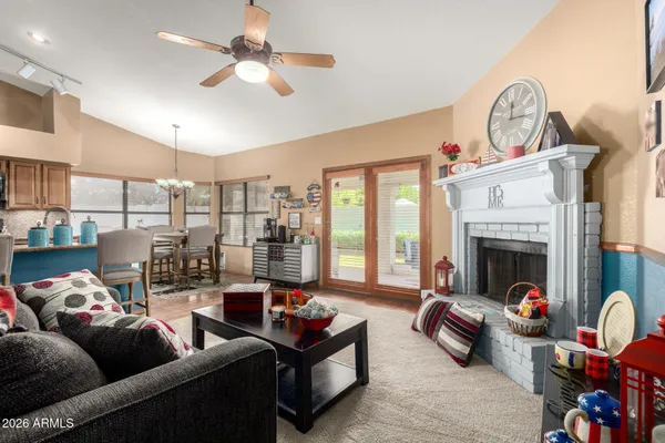a living room with furniture fireplace and a large window