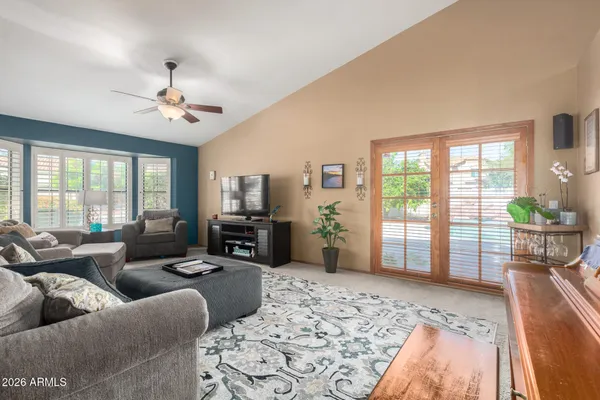 a living room with furniture ceiling fan and a rug