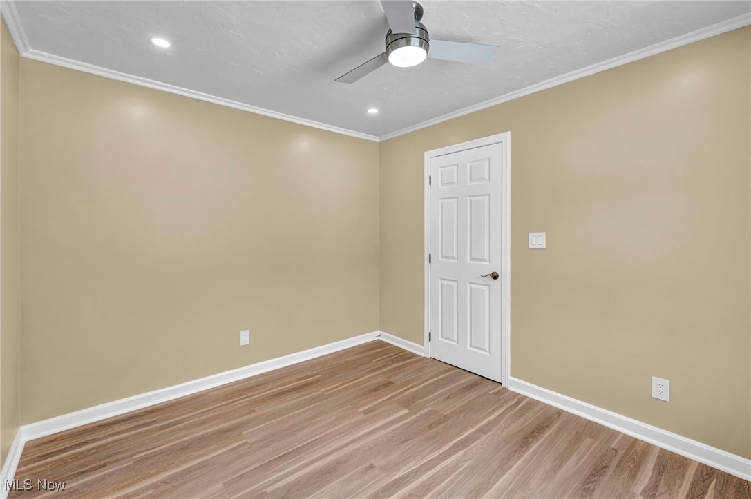 1447 East Sprague Road Independence, OH 44131 - Photo 29 of 47 Unfurnished room featuring hardwood / wood-style floors, crown molding, and ceiling fan