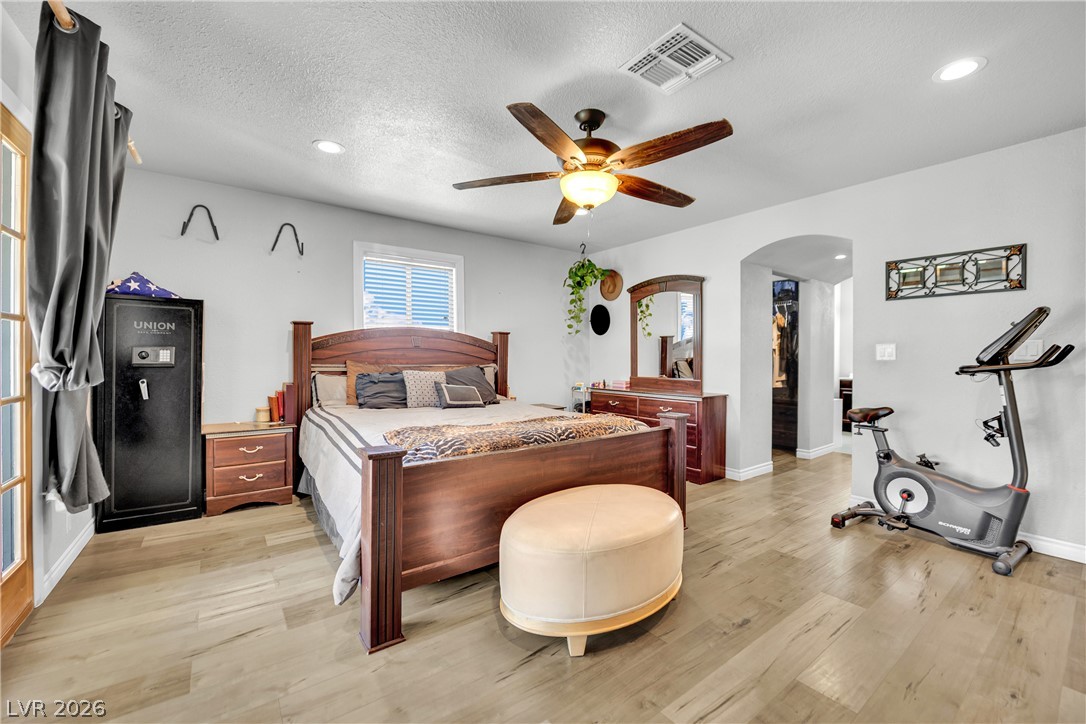 420 North Racetrack Road Henderson, NV 89015 - Photo 6 of 52 Well-lit primary bedroom featuring a ceiling fan and elegant flooring.