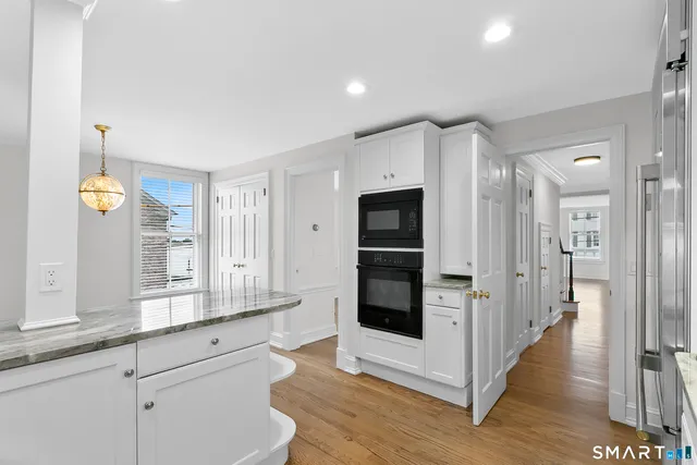 a kitchen with stainless steel appliances a refrigerator and a stove