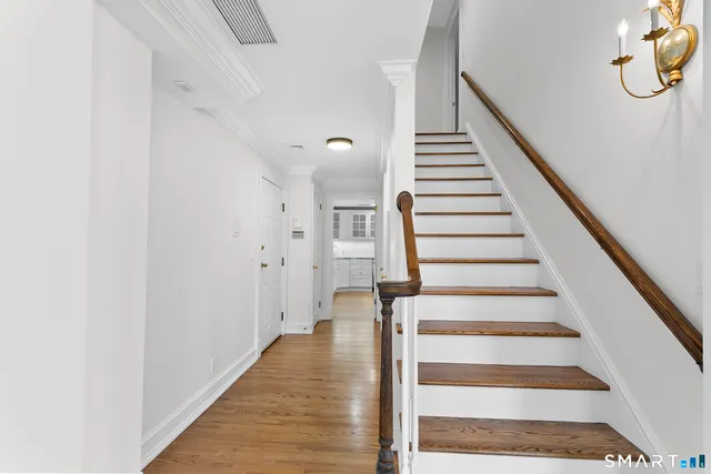 a view of entryway and hall with wooden floor