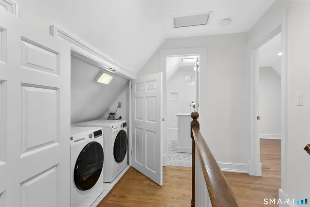 a view of a hallway with washer and dryer