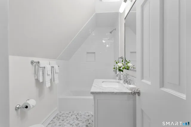 a bathroom with a sink a mirror and a shower