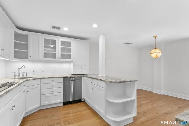 a spacious bathroom with a granite countertop sink and a window