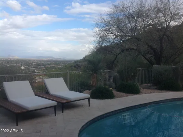 a view of a terrace with couches and wooden fence