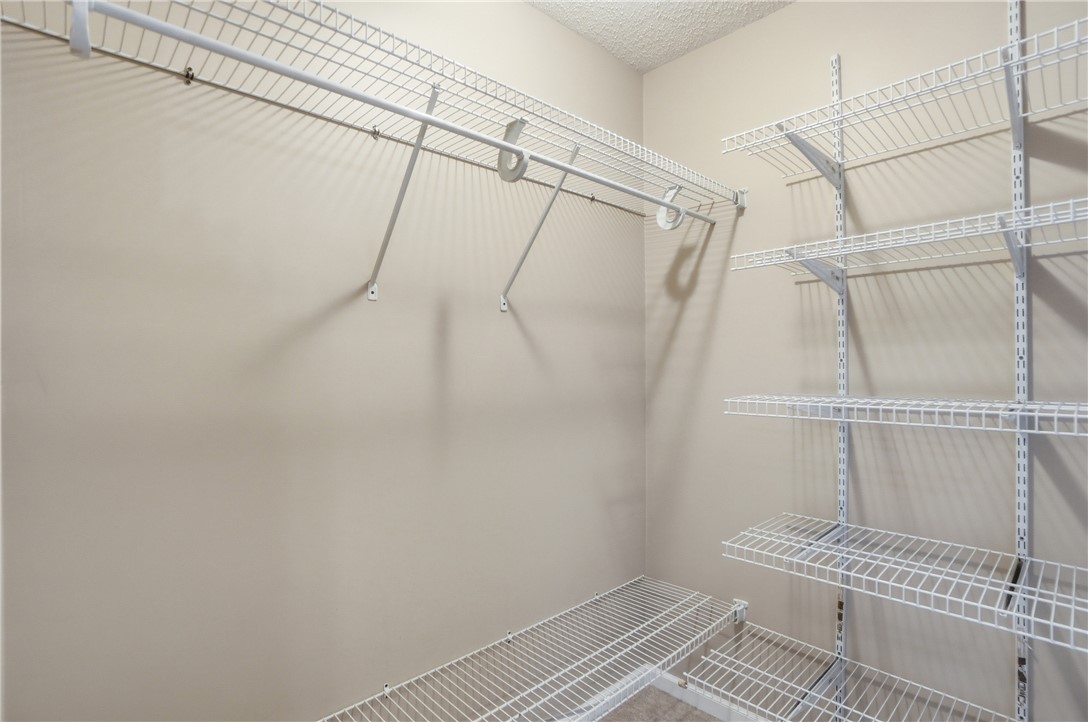 1208 Jarva Lane Springboro, OH 45066 - Photo 37 of 75 This spacious walk-in closet offers extensive wire shelving and hanging rods for organized storage.