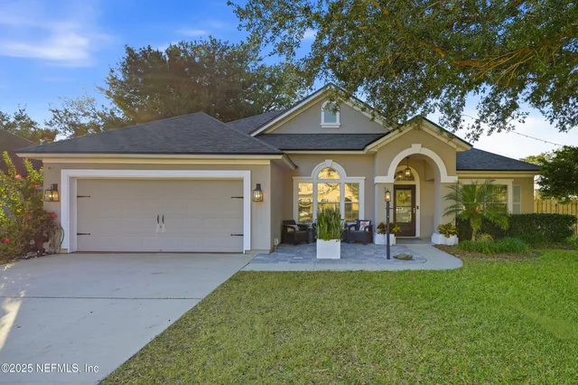 a front view of a house with garden and porch