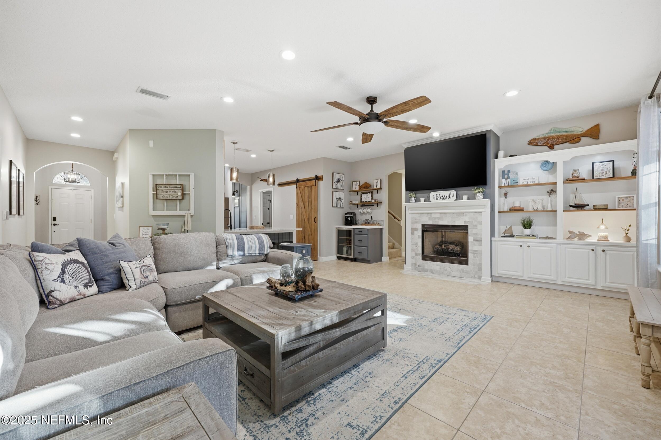 177 Summerhill Circle St. Augustine, FL 32086 - Photo 11 of 42 a living room with furniture a fireplace and a flat screen tv