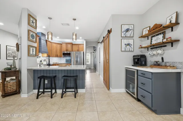 a kitchen with cabinets and chairs