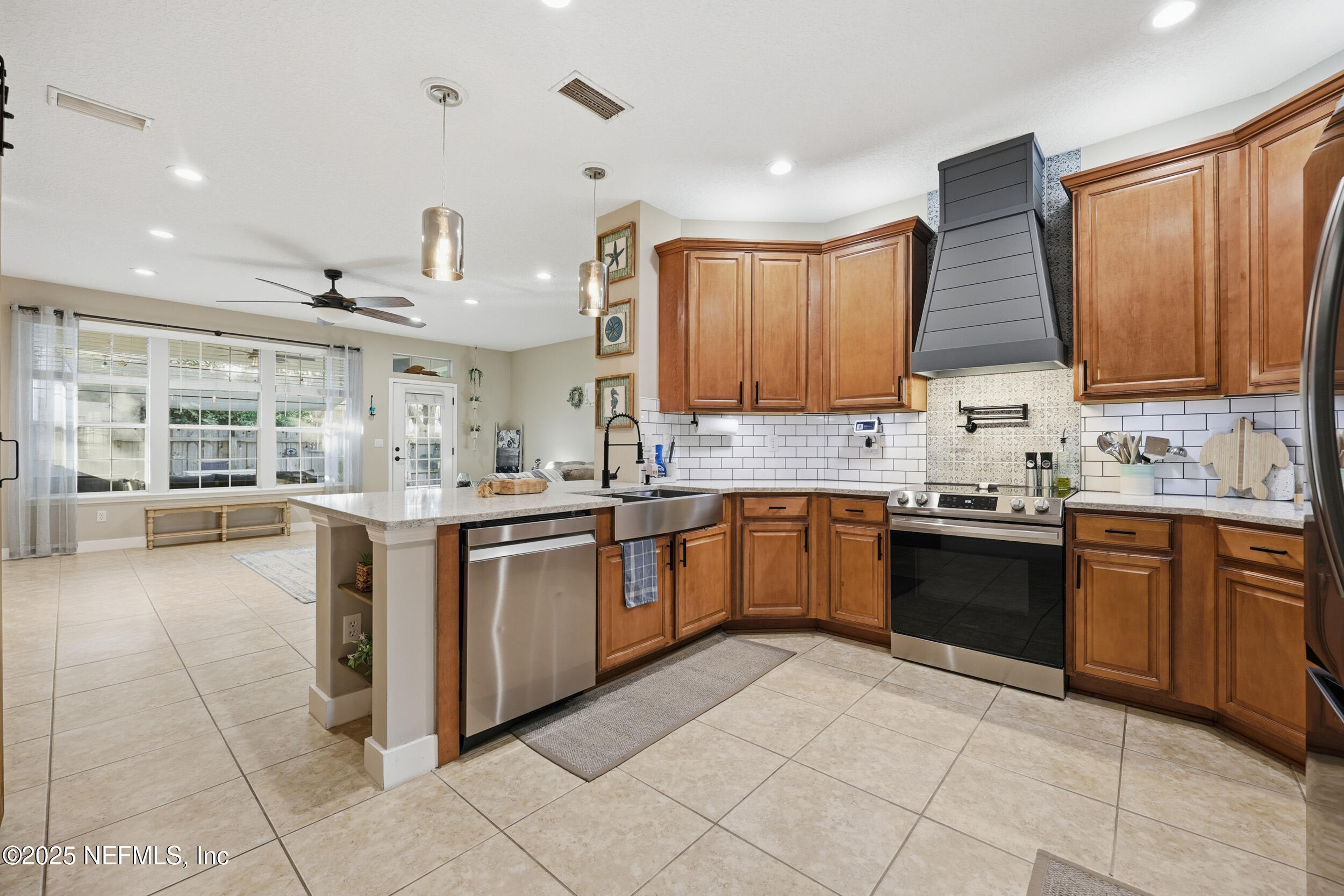 177 Summerhill Circle St. Augustine, FL 32086 - Photo 14 of 42 a kitchen with stainless steel appliances granite countertop a stove sink and cabinets