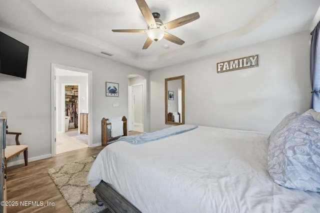 a bedroom with a bed and a television